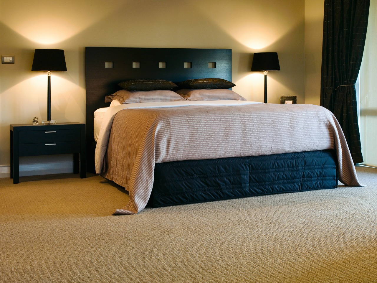 Bedroom with black bed, natural coloured bedding and bed, bed frame, bedroom, ceiling, floor, flooring, furniture, hardwood, home, interior design, mattress, room, suite, wall, wood, wood flooring, brown