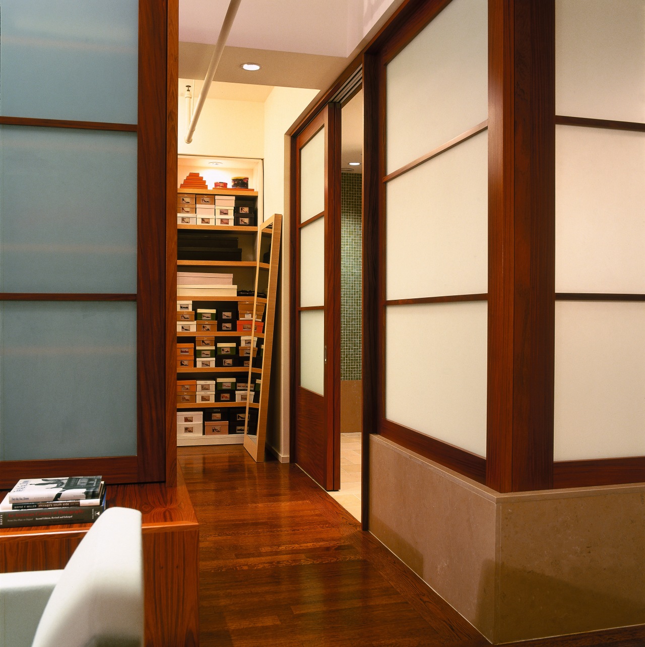 view of this master bedroom leading to the bookcase, cabinetry, door, floor, flooring, furniture, interior design, shelf, shelving, brown, orange