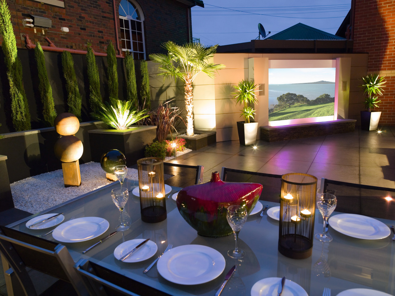 view of the outdoor dining area featuring alluminium home, lighting, black