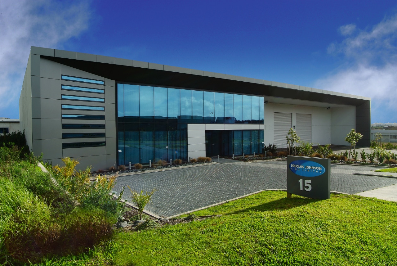 Exterior view of commericlal building, showing concrete walls architecture, commercial building, corporate headquarters, facade, home, house, property, real estate, sky, blue