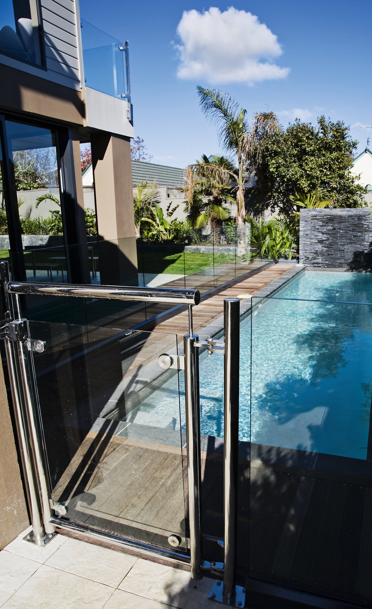 A view of some balustrades from ProStainless. house, outdoor structure, property, real estate, reflection, sky, swimming pool, water, black