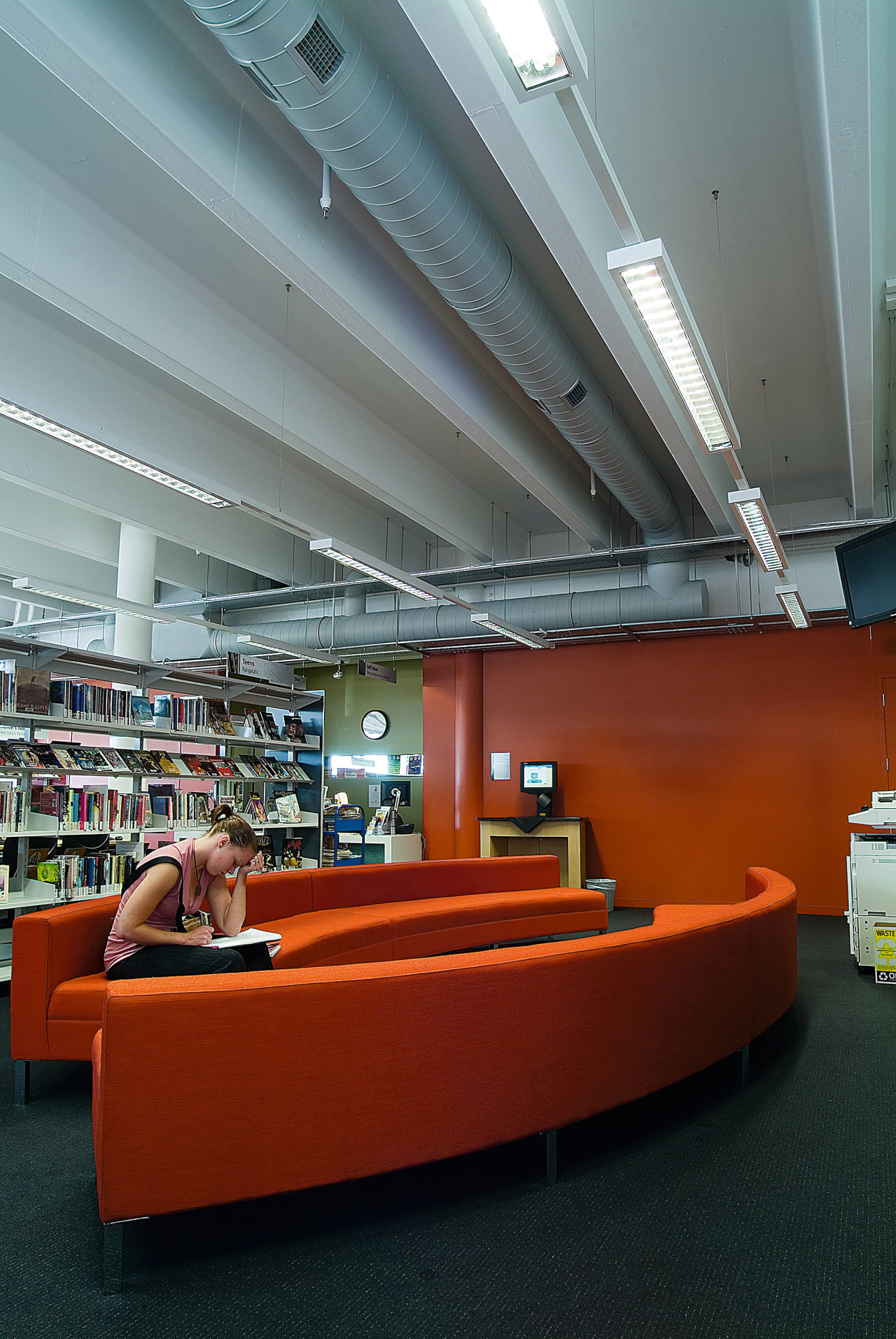 Civic library area with orange sofas, and view architecture, ceiling, daylighting, furniture, institution, interior design, library, gray, red