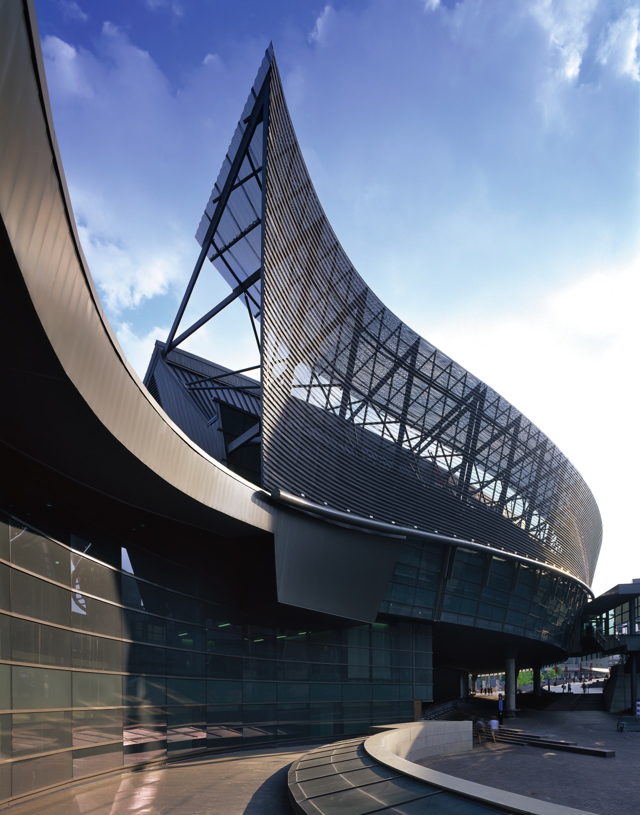 An exterior view of the complex. architecture, building, corporate headquarters, daytime, fixed link, headquarters, landmark, metropolis, metropolitan area, reflection, sky, skyscraper, structure, black, teal