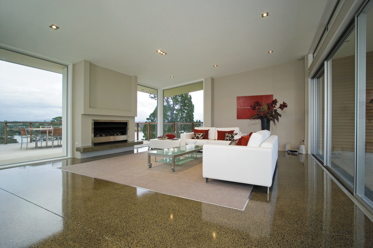 A view of a polished concrete floor. apartment, architecture, estate, floor, flooring, hardwood, home, house, interior design, living room, penthouse apartment, property, real estate, room, window, wood flooring, gray