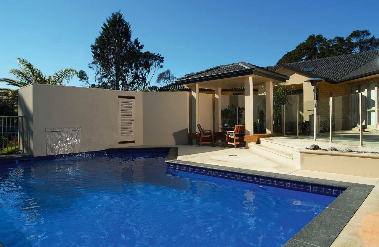 A view of a swimming pool by Mayfair backyard, estate, facade, home, house, leisure, property, real estate, residential area, resort, swimming pool, villa, blue