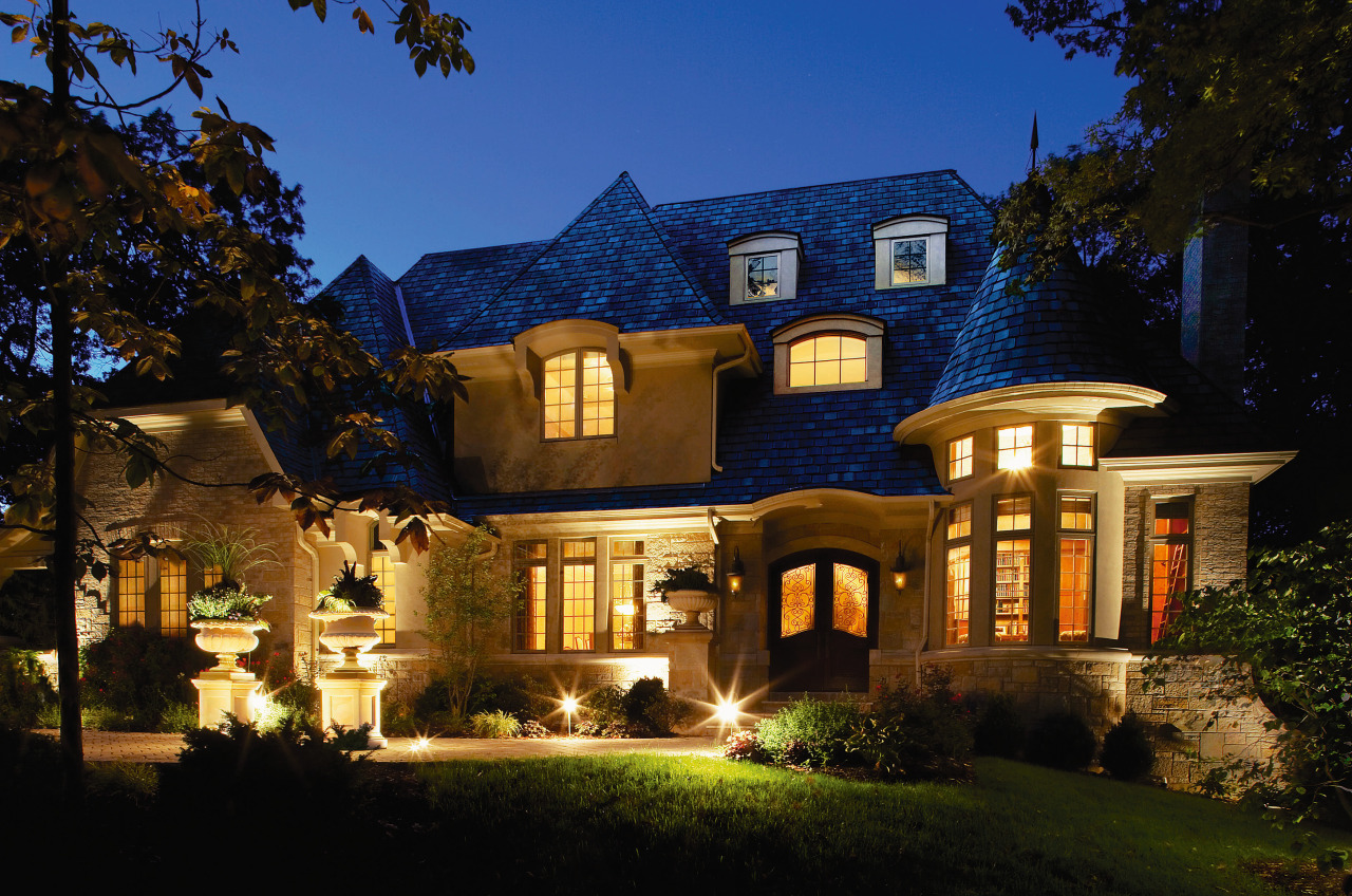 view of this house featuring timber high divided building, cottage, estate, evening, facade, historic house, home, house, landscape lighting, lighting, mansion, property, real estate, residential area, sky, villa, black, blue