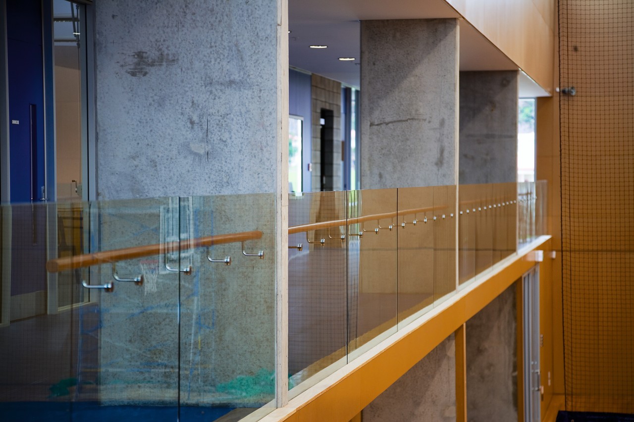 A view of a gym built by Aspec architecture, daylighting, floor, flooring, glass, handrail, house, wall, gray, brown