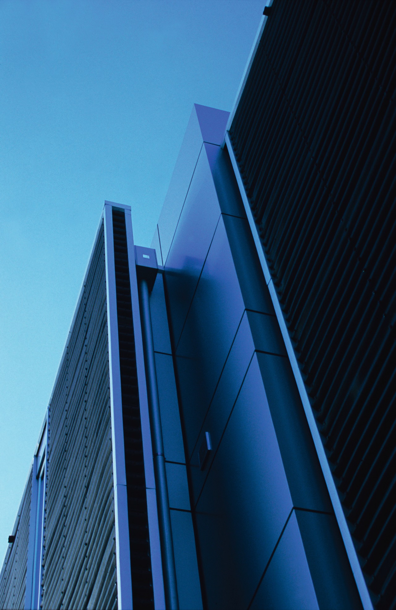 A view of a home by ADNZ. angle, architecture, building, commercial building, corporate headquarters, daylighting, daytime, facade, headquarters, landmark, line, metropolis, metropolitan area, reflection, sky, skyscraper, structure, tower, tower block, urban area, blue, teal, black