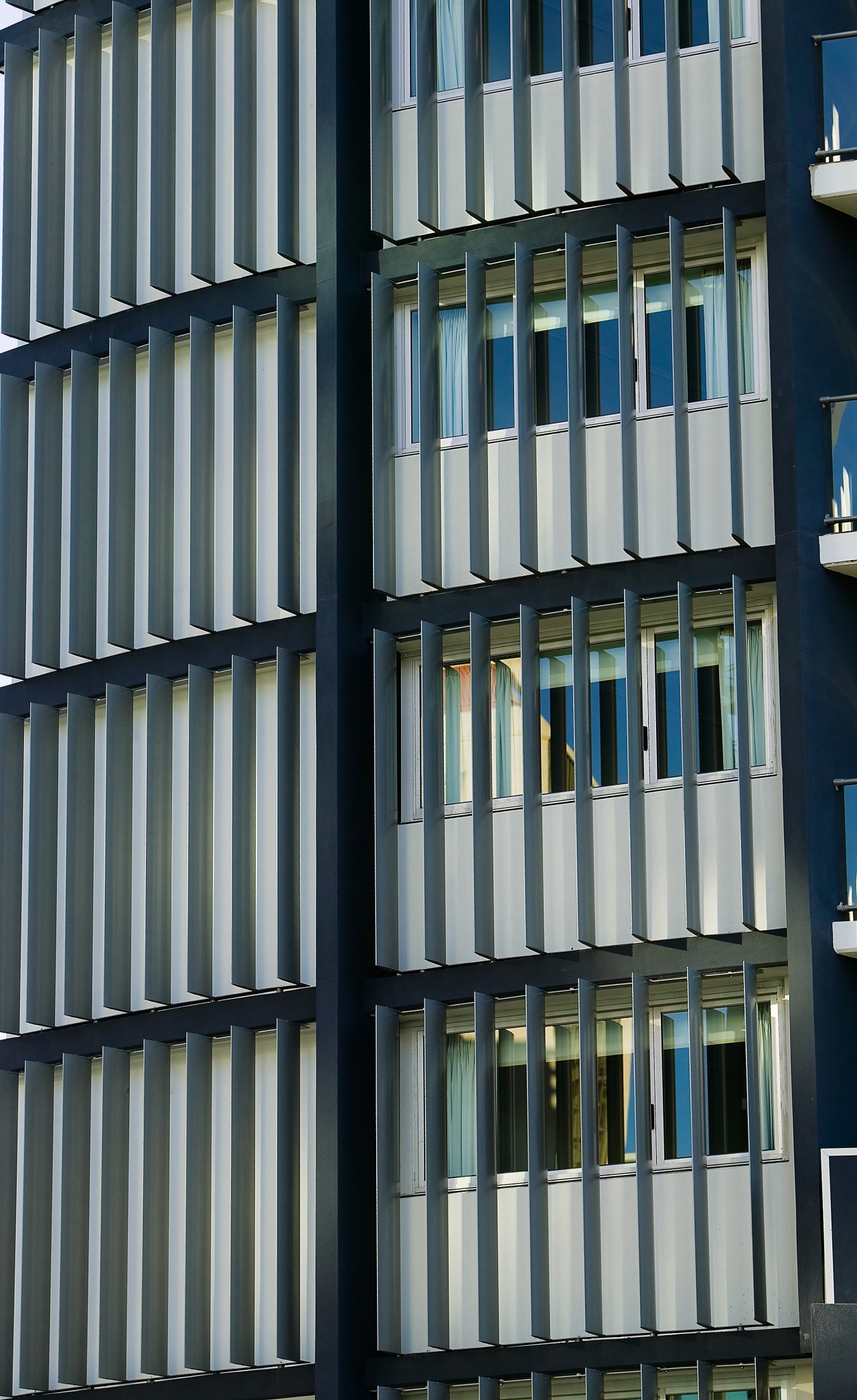 A view of some louvres from Lowline. architecture, building, commercial building, condominium, daytime, facade, glass, line, metropolis, metropolitan area, structure, tower block, urban area, window, black, gray