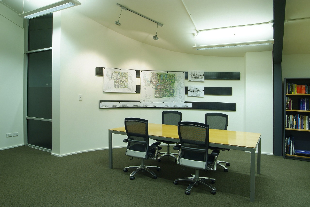 A view of a cream coloured painted wall. classroom, furniture, institution, interior design, office, real estate, green, white