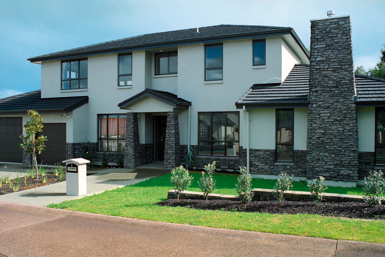 Large two storey home with cream cladding, stone cottage, estate, facade, home, house, neighbourhood, property, real estate, residential area, roof, siding, suburb, window, yard, gray, black