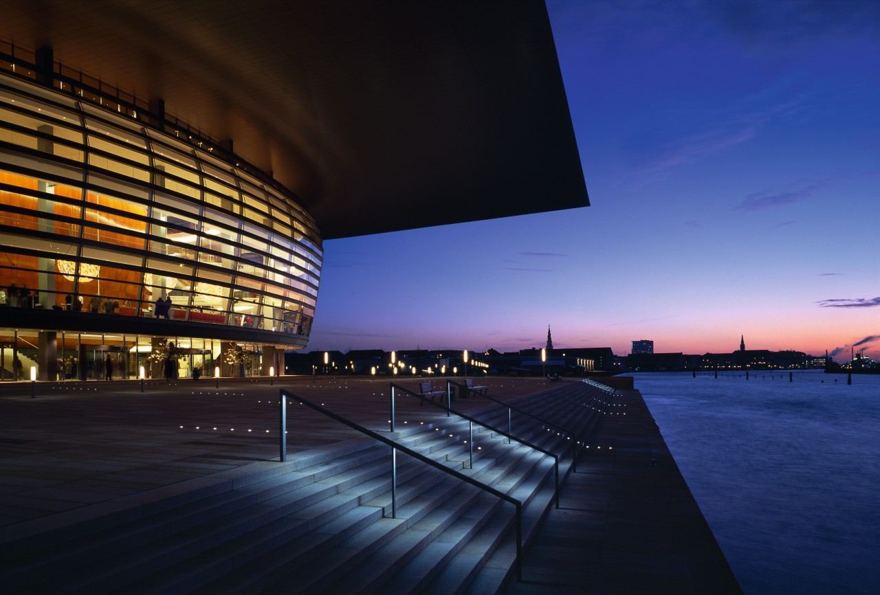 An exteior view of the building. architecture, atmosphere, building, city, cityscape, convention center, corporate headquarters, dawn, dusk, evening, headquarters, horizon, landmark, metropolis, metropolitan area, night, opera house, performing arts center, reflection, sky, structure, sunlight, sunset, water, blue, black