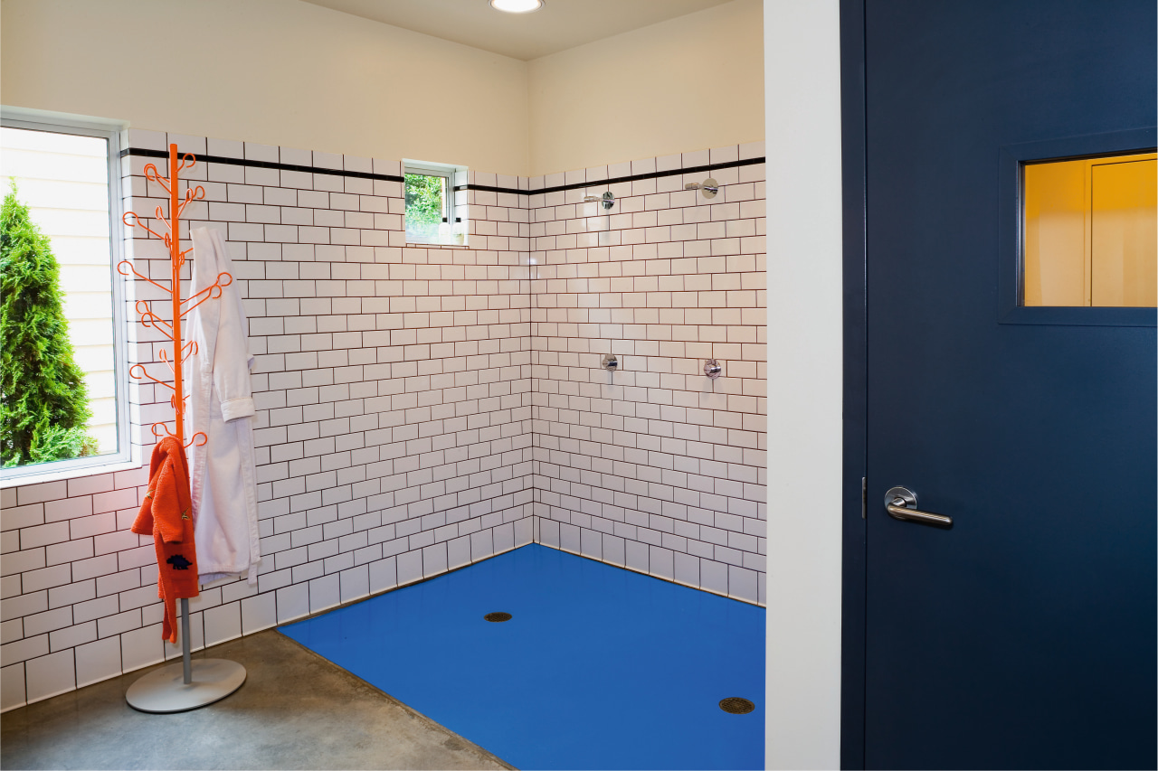 view of this bathroom featuring subway tiles on architecture, bathroom, floor, flooring, house, interior design, room, tile, wall, gray, blue