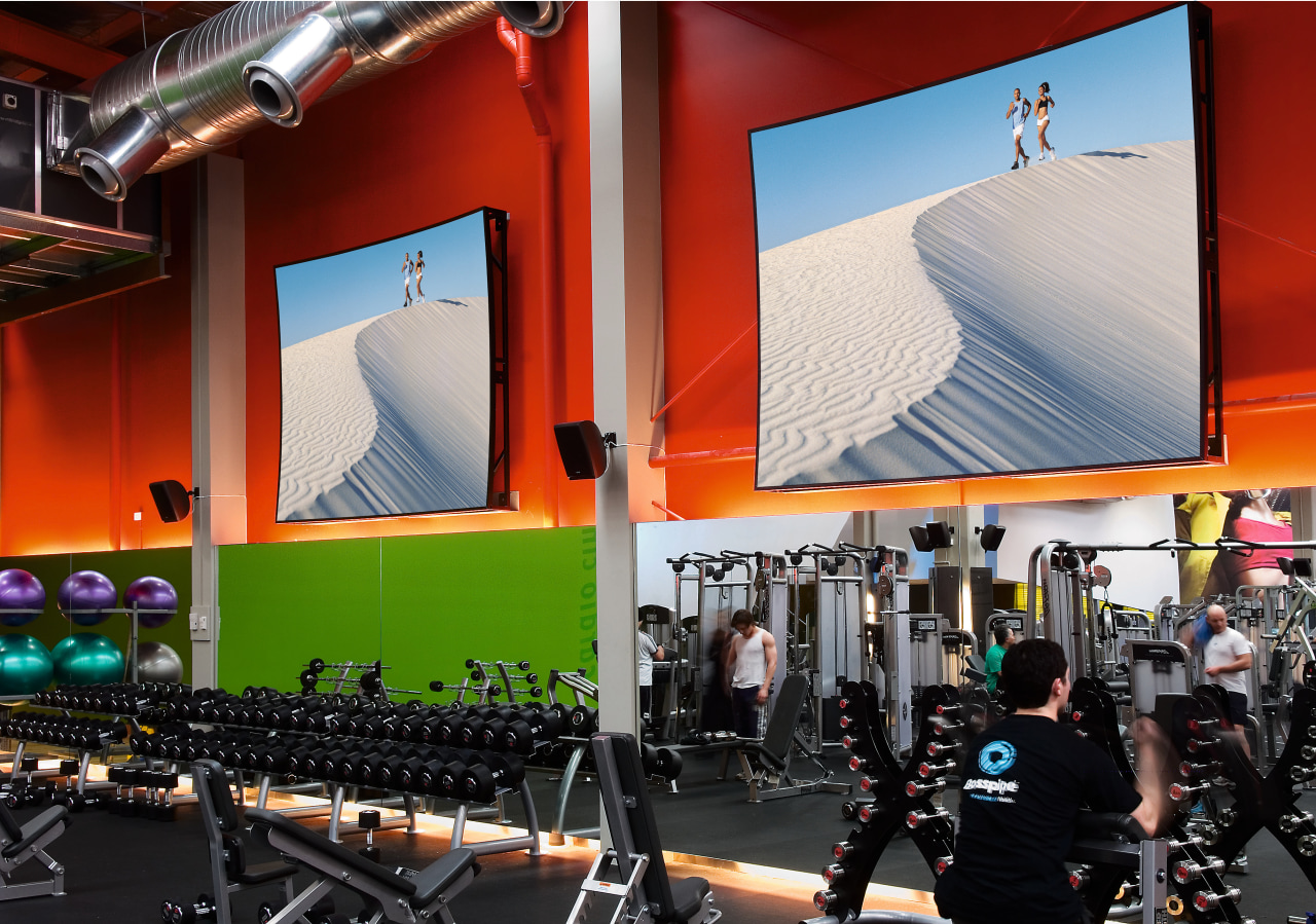 view of the projector screens installed by Vidcom auditorium, gym, room, sport venue, structure, red, black