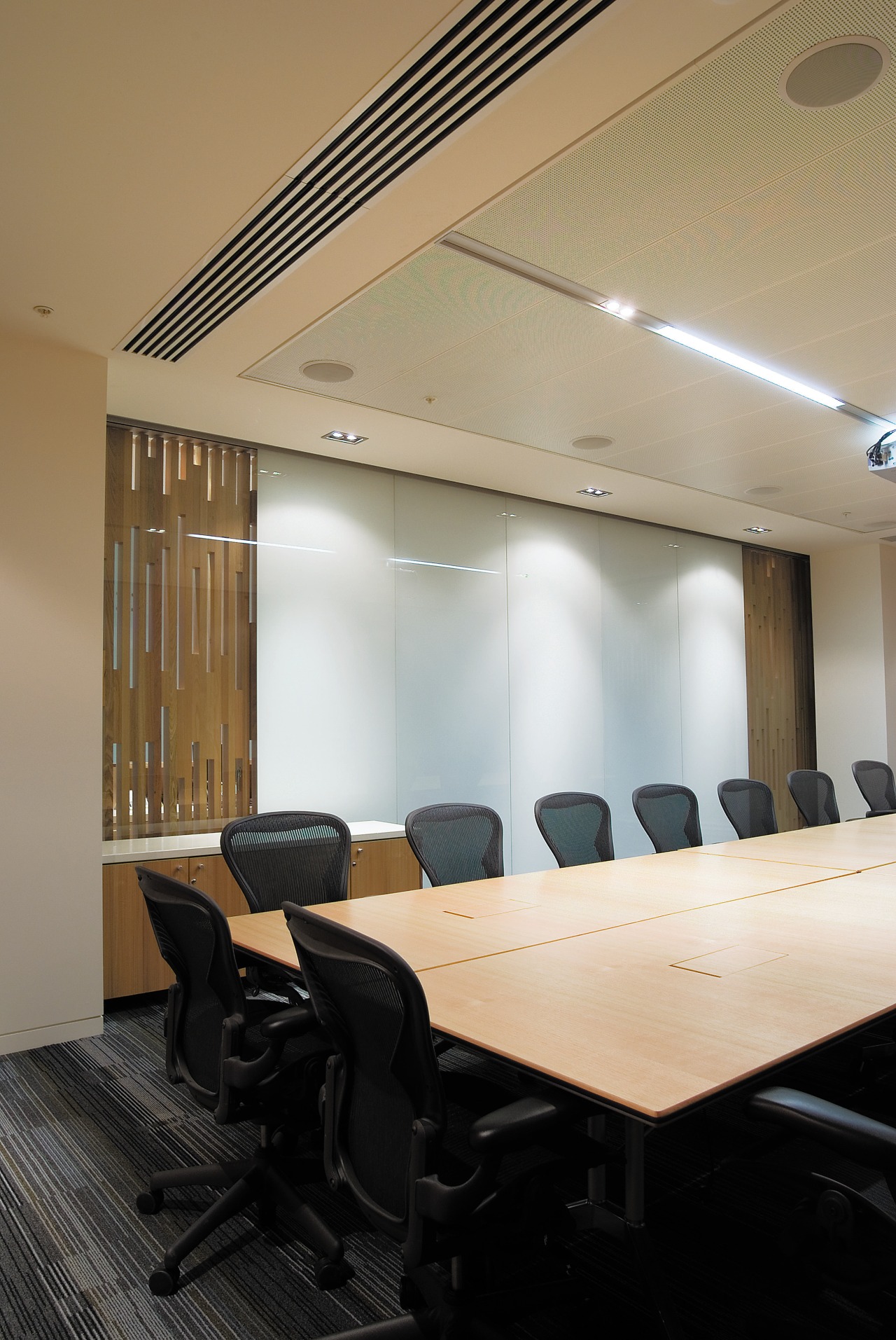 A view of a air conditioning system by architecture, ceiling, conference hall, daylighting, furniture, interior design, light fixture, lighting, office, table, black, orange