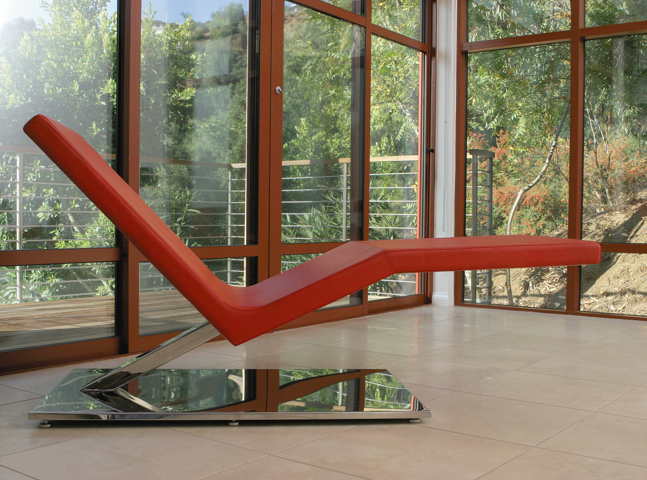 view of this minimalist lounge featuring a white chair, furniture, glass, outdoor furniture, table, window, gray