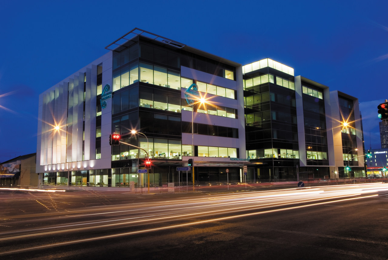 A view of the Air NZ building. apartment, architecture, building, city, commercial building, condominium, convention center, corporate headquarters, downtown, facade, headquarters, hotel, metropolis, metropolitan area, mixed use, night, property, real estate, residential area, sky, black, blue