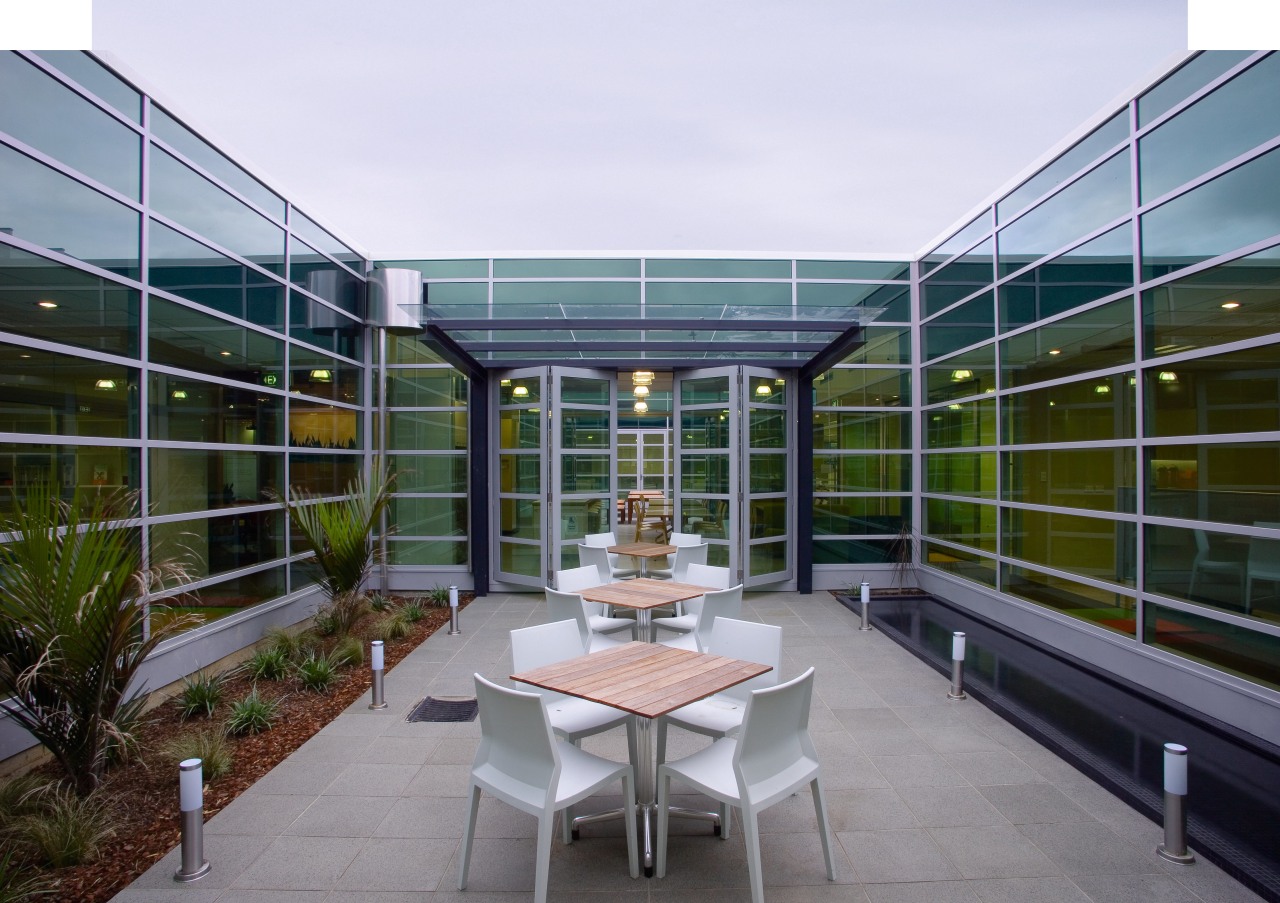 A view of the Pearson Publishing building. apartment, architecture, condominium, corporate headquarters, courtyard, daylighting, facade, house, mixed use, real estate, roof, white, gray