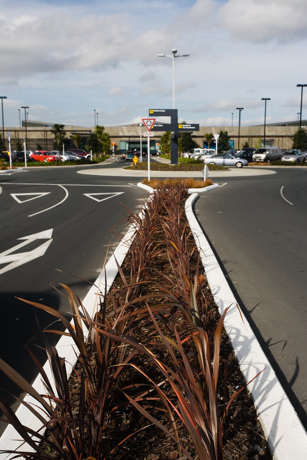 A view of some landscaping by Mace Contractors. asphalt, car, grass, lane, plant, road, sky, tree, vehicle, black, gray