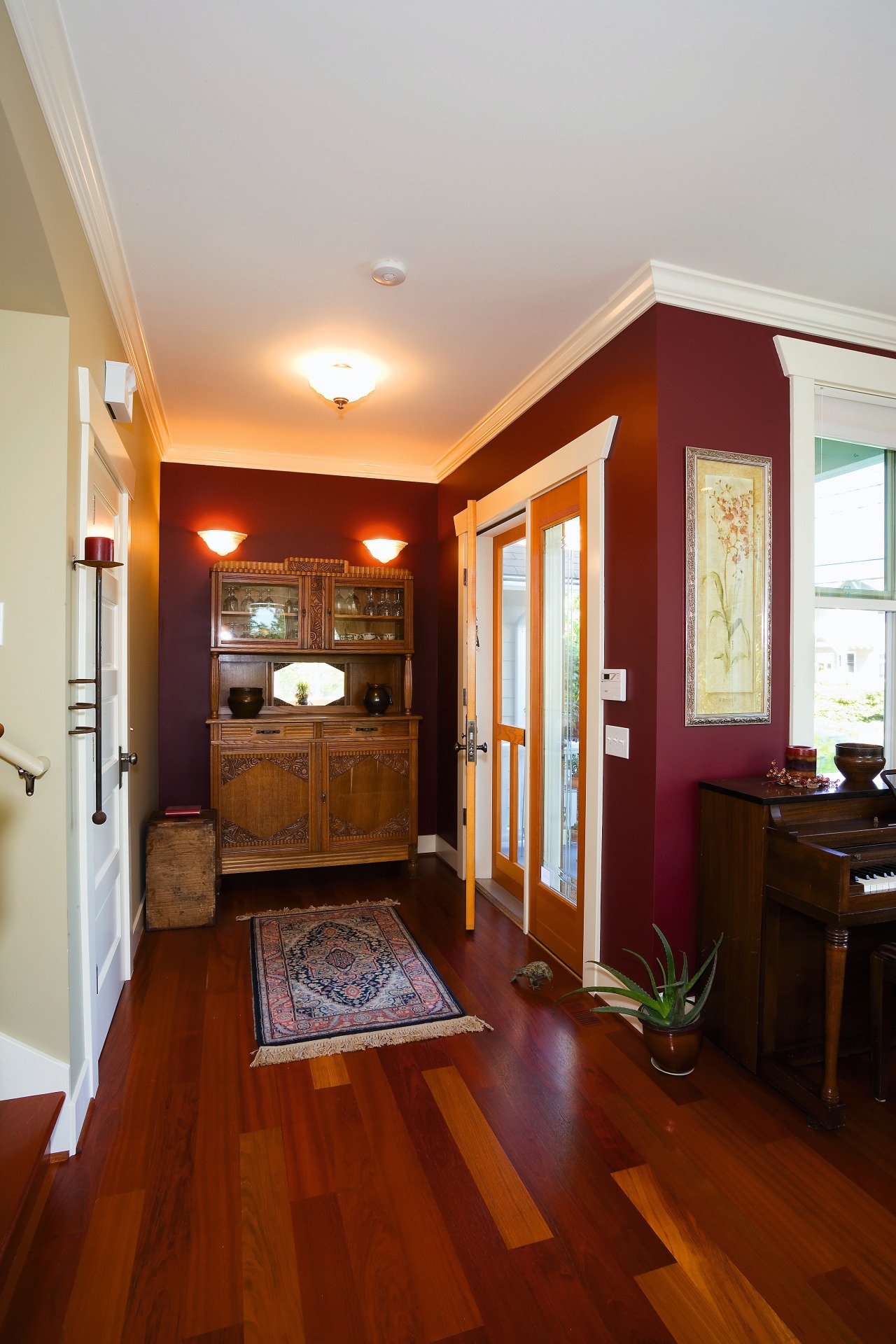 A view of a wooden display unit, wooden ceiling, dining room, door, floor, flooring, hardwood, home, house, interior design, laminate flooring, living room, real estate, room, wall, window, wood, wood flooring, wood stain, red