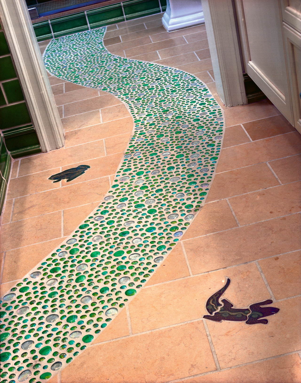 view of the glass and ceramic path in floor, flooring, tile, orange