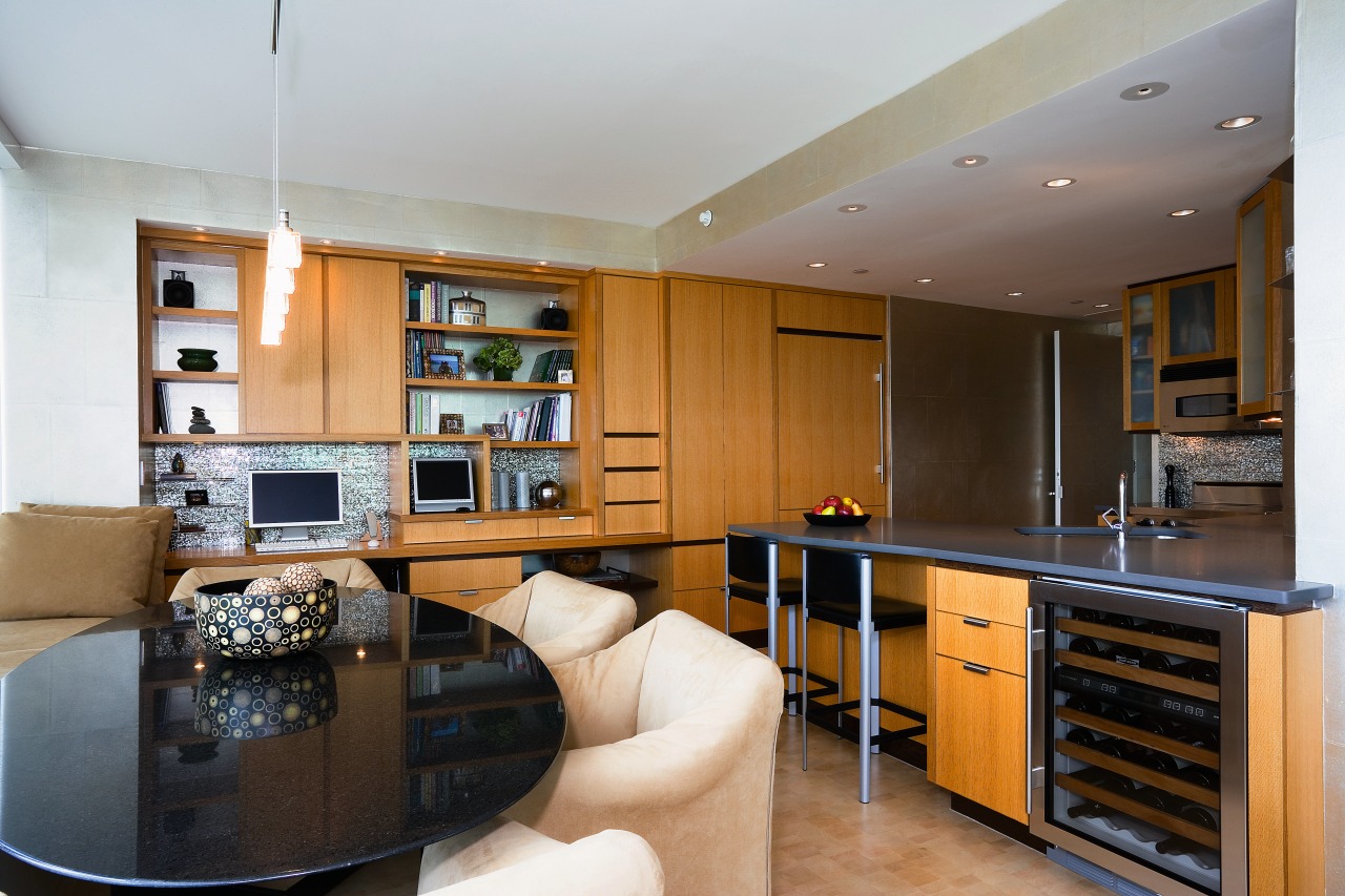 View of the kitchen and dining area featuring cabinetry, countertop, interior design, kitchen, living room, real estate, room