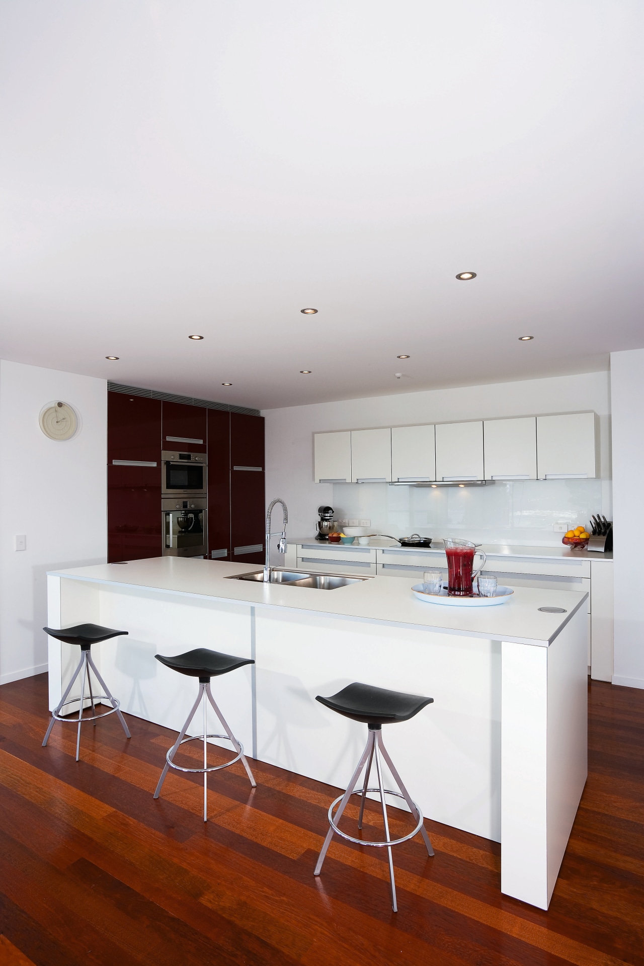 Spanish Red lacquered cabinets contrast with pure white apartment, architecture, ceiling, floor, furniture, house, interior design, kitchen, real estate, table, white