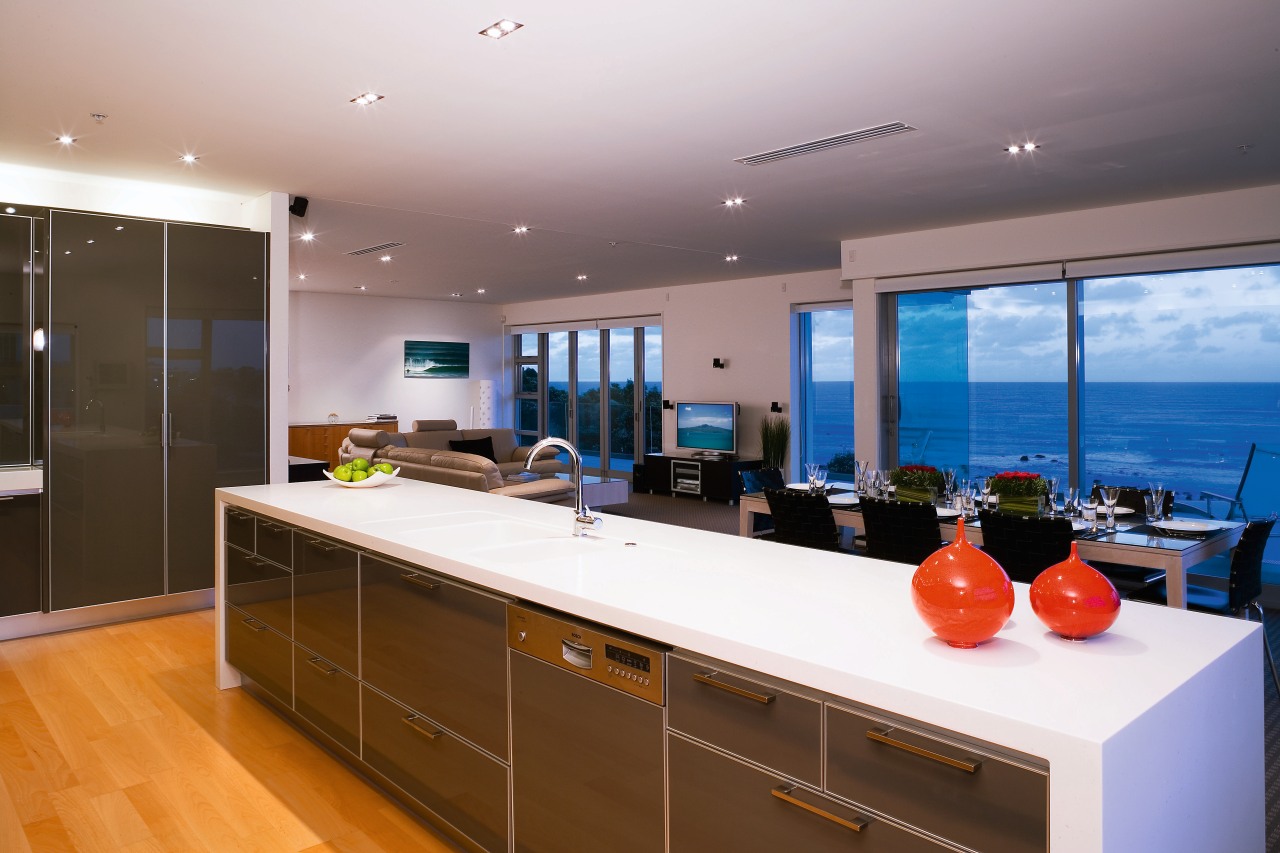 A viewof the kitchen and dining areas, wooden countertop, interior design, kitchen, real estate, room, white