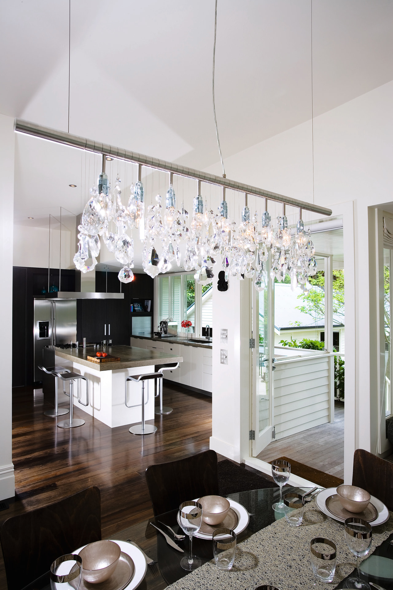 A view of the kitchen and dining areas, ceiling, chandelier, countertop, home, interior design, kitchen, light fixture, lighting, gray, white