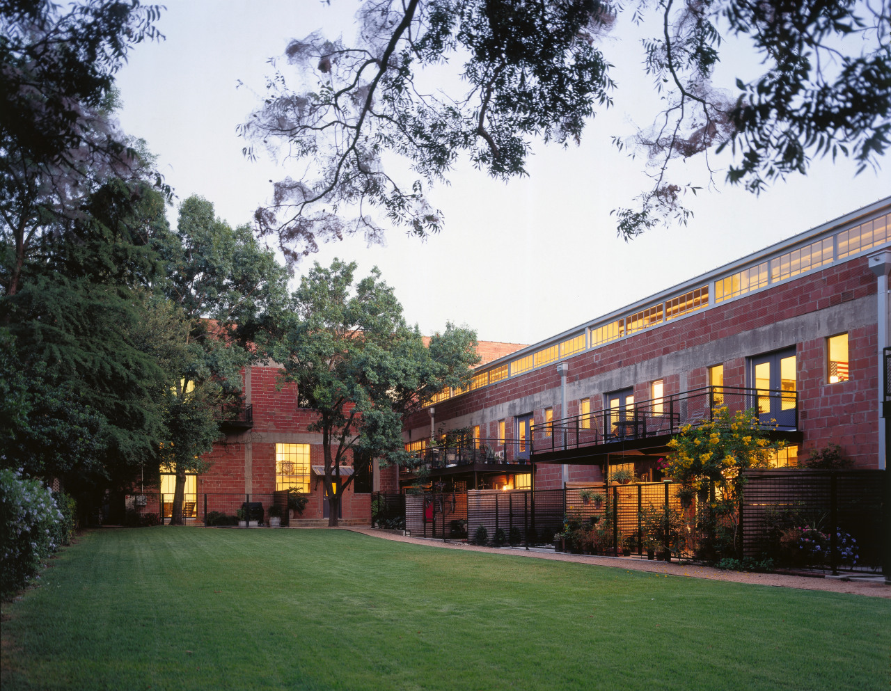 An exterior view of the old glass factories architecture, building, campus, city, corporate headquarters, estate, facade, grass, home, house, mixed use, plant, property, real estate, residential area, tree, white, black