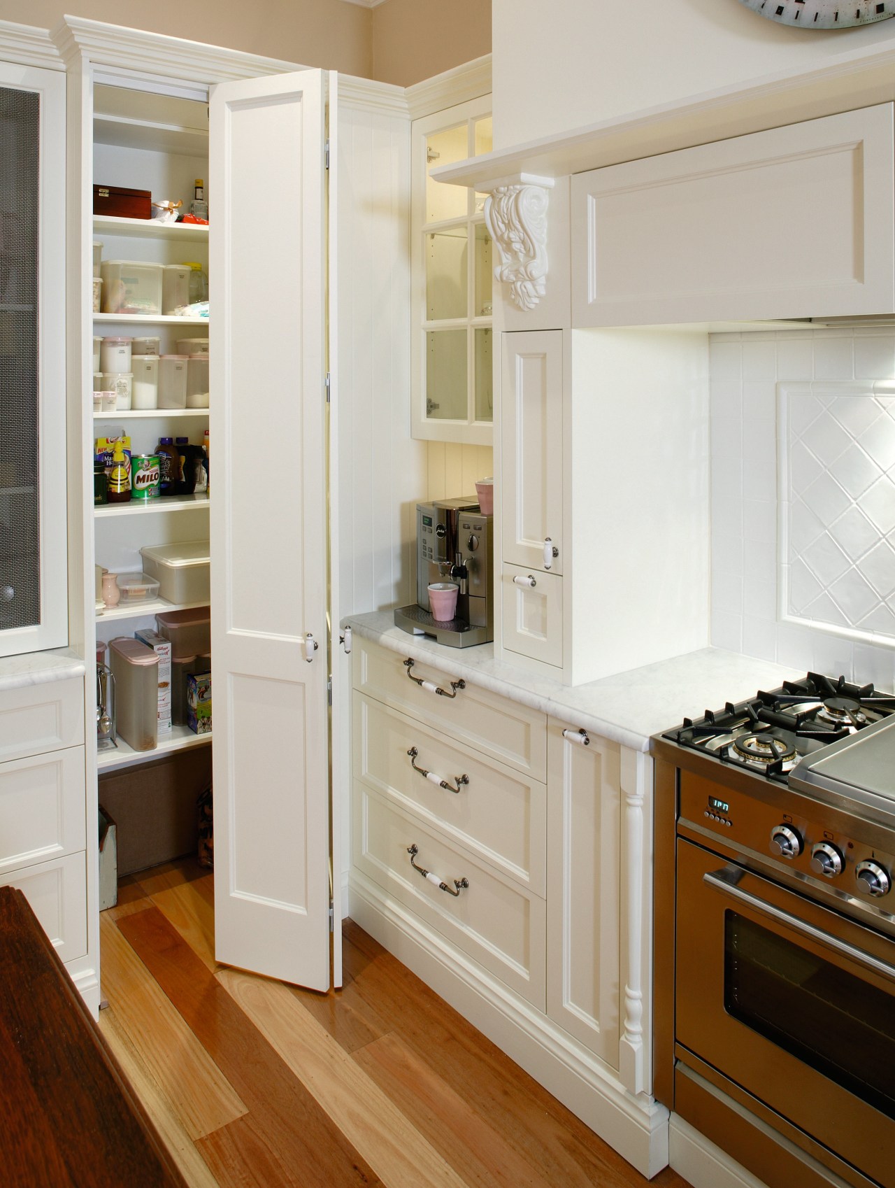 A view of a kitchen designed by Provincial cabinetry, countertop, cuisine classique, cupboard, floor, flooring, furniture, hardwood, home, home appliance, interior design, kitchen, room, shelf, shelving, wood flooring, gray, brown