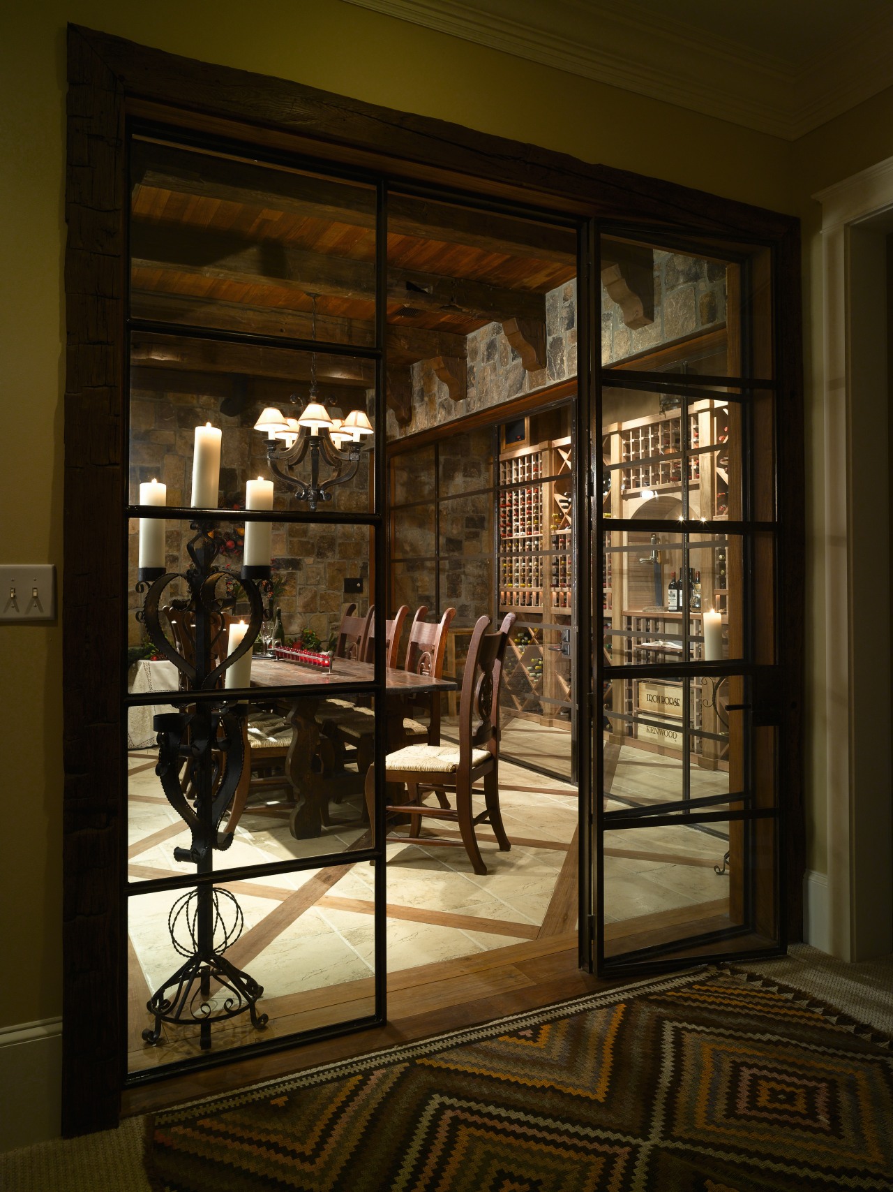 View of wine cellar with stone floor and door, furniture, interior design, lobby, window, brown