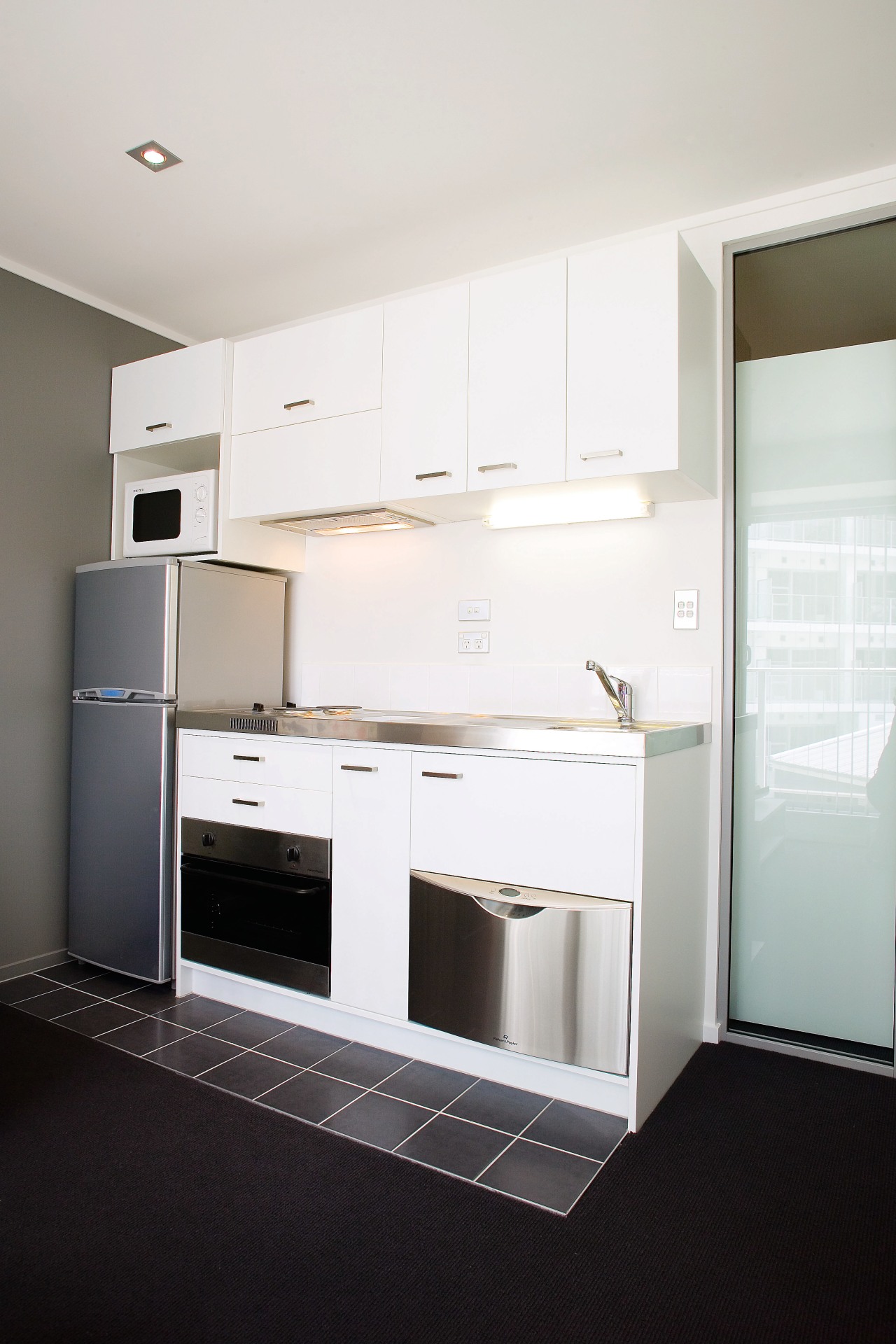 View of this Kitchen in the Volt apartment cabinetry, countertop, floor, home appliance, interior design, kitchen, major appliance, real estate, room, white