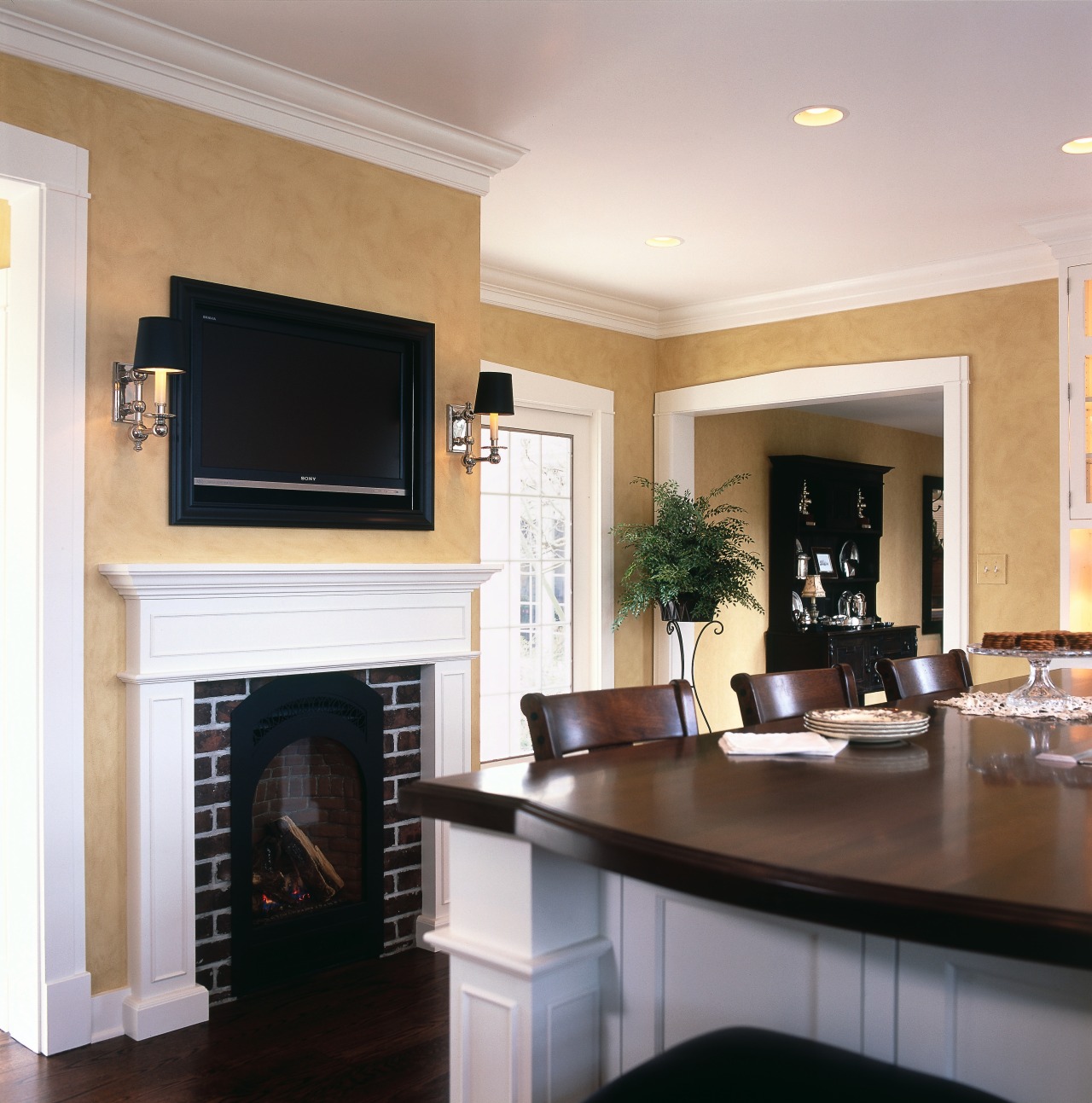 View of kitchen with white cabinetry and walnut cabinetry, ceiling, fireplace, floor, flooring, furniture, hardwood, hearth, home, interior design, living room, room, wall, wood flooring, gray