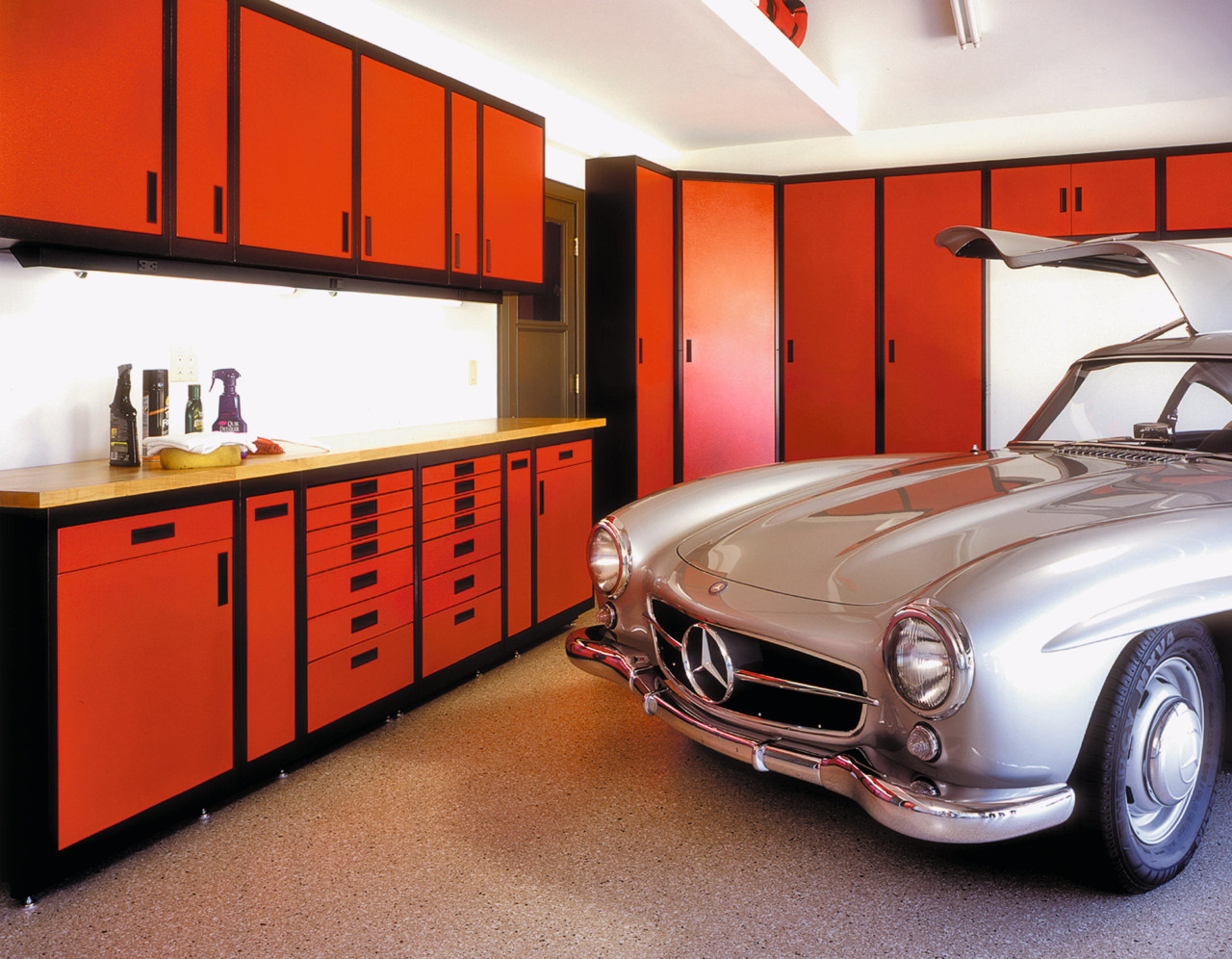 View of home garage with red storage cabinets automotive design, automotive exterior, car, classic, interior design, motor vehicle, personal luxury car, sports car, vehicle, red, white