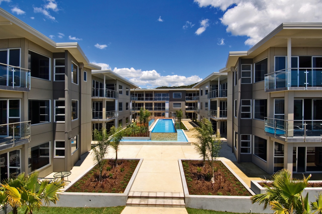 View of the outdoor area of the apartment apartment, building, condominium, corporate headquarters, estate, home, hotel, mansion, mixed use, property, real estate, residential area, resort, villa