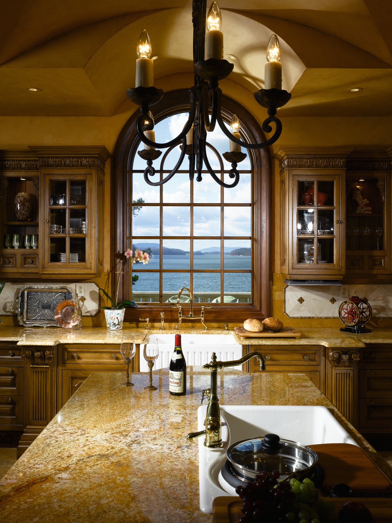 A view of this elegant kitchen featuring gold cabinetry, ceiling, countertop, estate, home, interior design, kitchen, lighting, room, window, brown