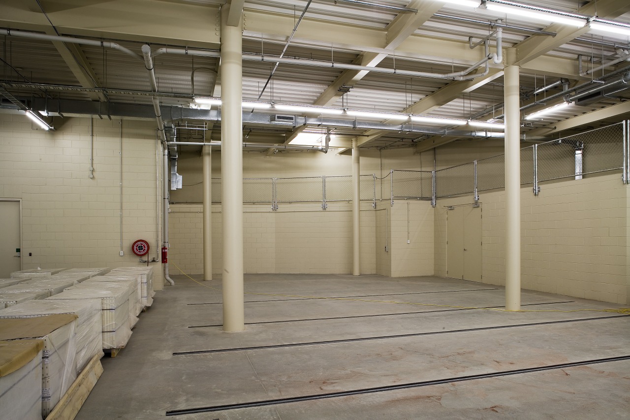 View of the new basement storage area in floor, flooring, structure, warehouse, gray, brown