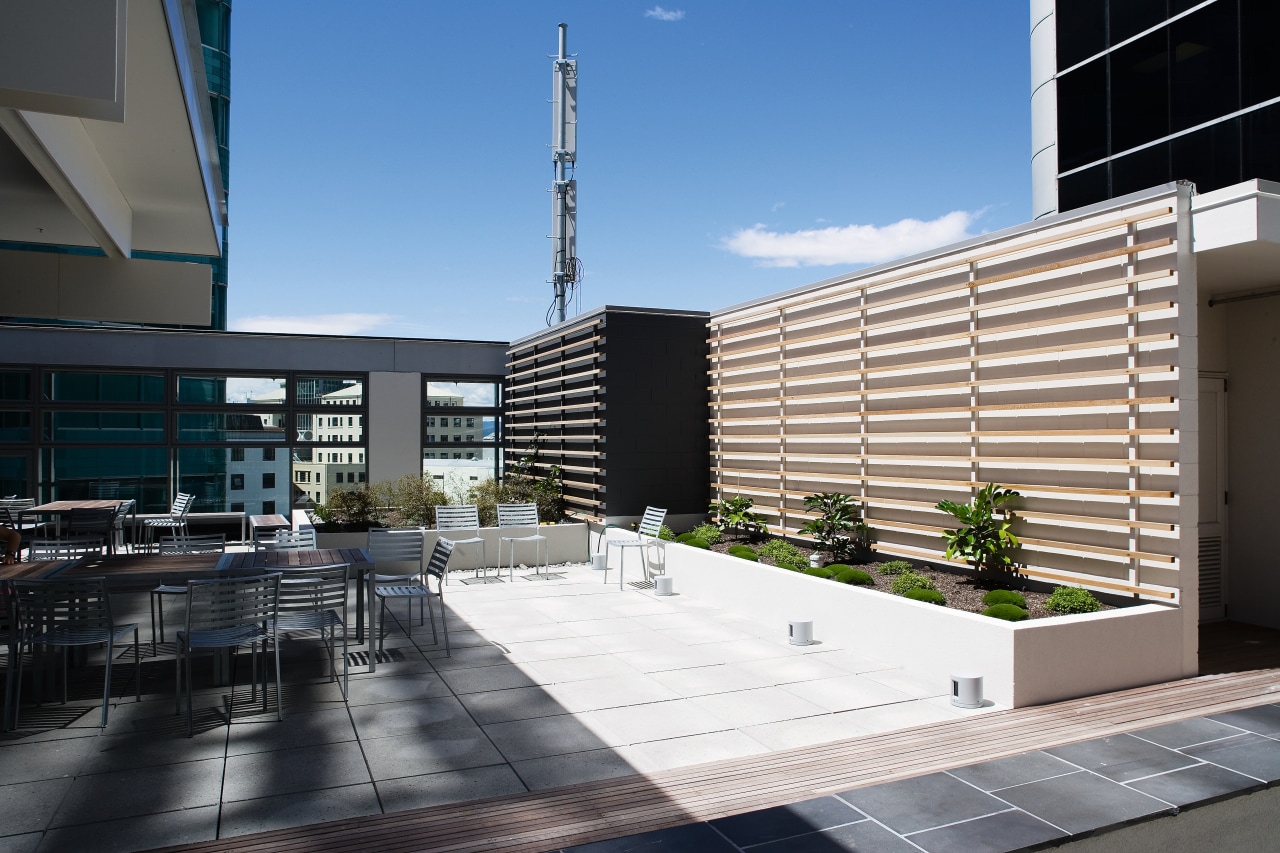View of the outdoor cafe featuring planter boxes, apartment, architecture, building, commercial building, condominium, corporate headquarters, daylighting, facade, headquarters, mixed use, real estate, residential area, urban design, black