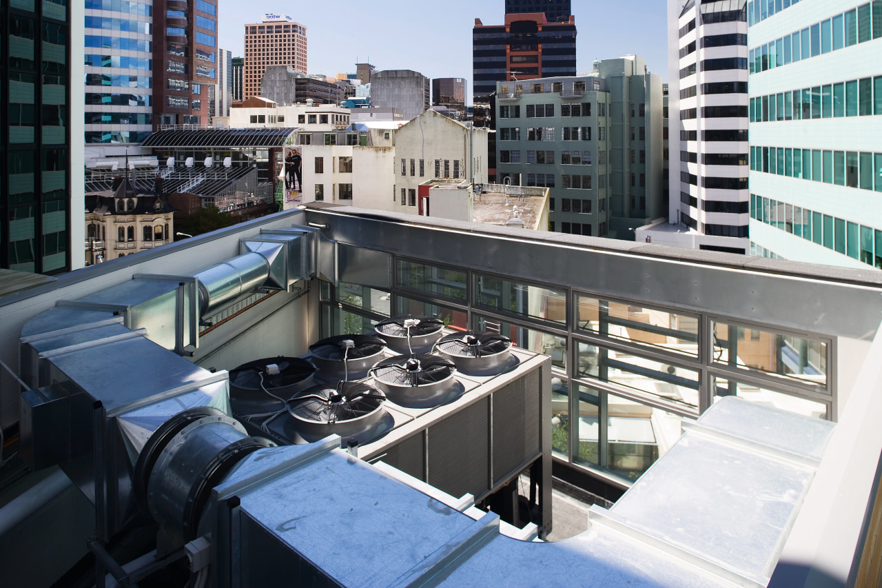 view of the rooftop featuring a 350KW heat building, city, condominium, downtown, metropolis, metropolitan area, roof, urban area, black, white