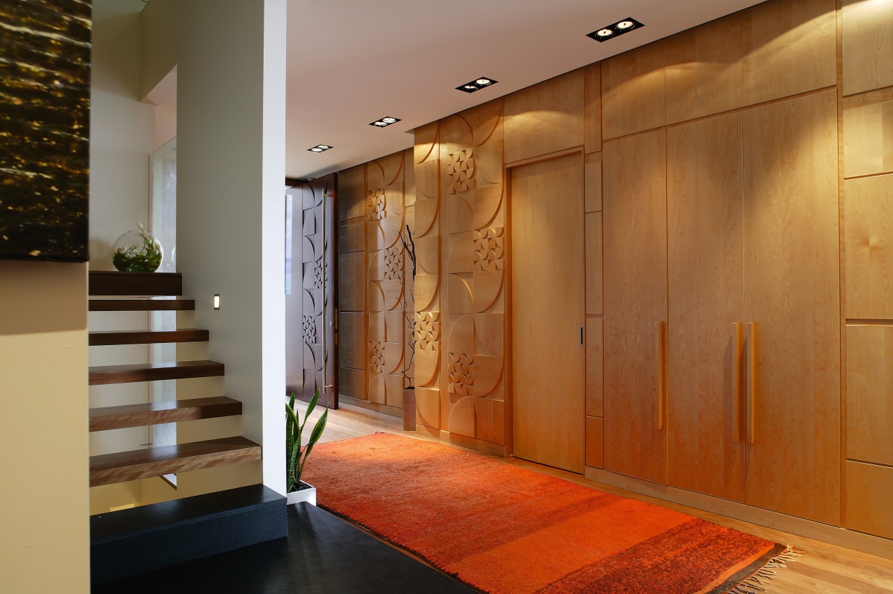 A view of the internal living areas featuring ceiling, door, floor, flooring, hardwood, interior design, lobby, wall, wood, wood flooring, wood stain, brown