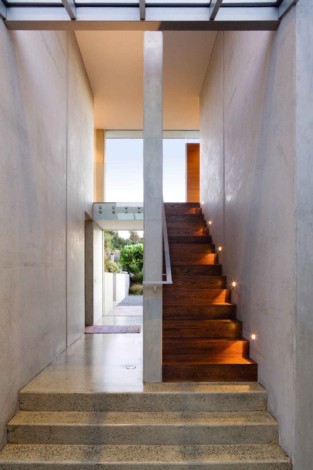 A view of a wooden staircase.  lights, architecture, daylighting, house, interior design, stairs, gray
