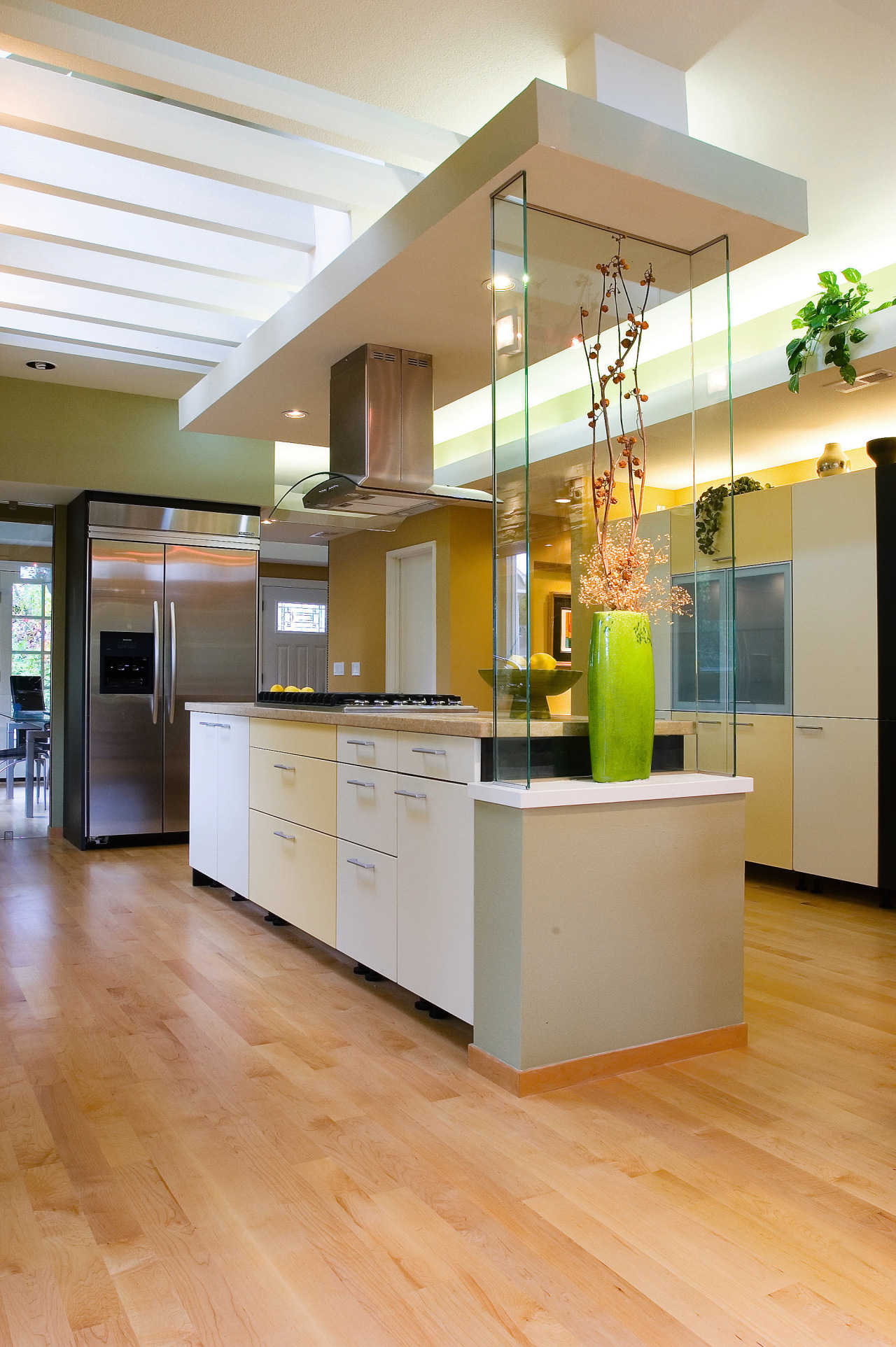 A view of this modern kitchen designed by cabinetry, ceiling, countertop, floor, flooring, hardwood, interior design, kitchen, laminate flooring, wood flooring, orange