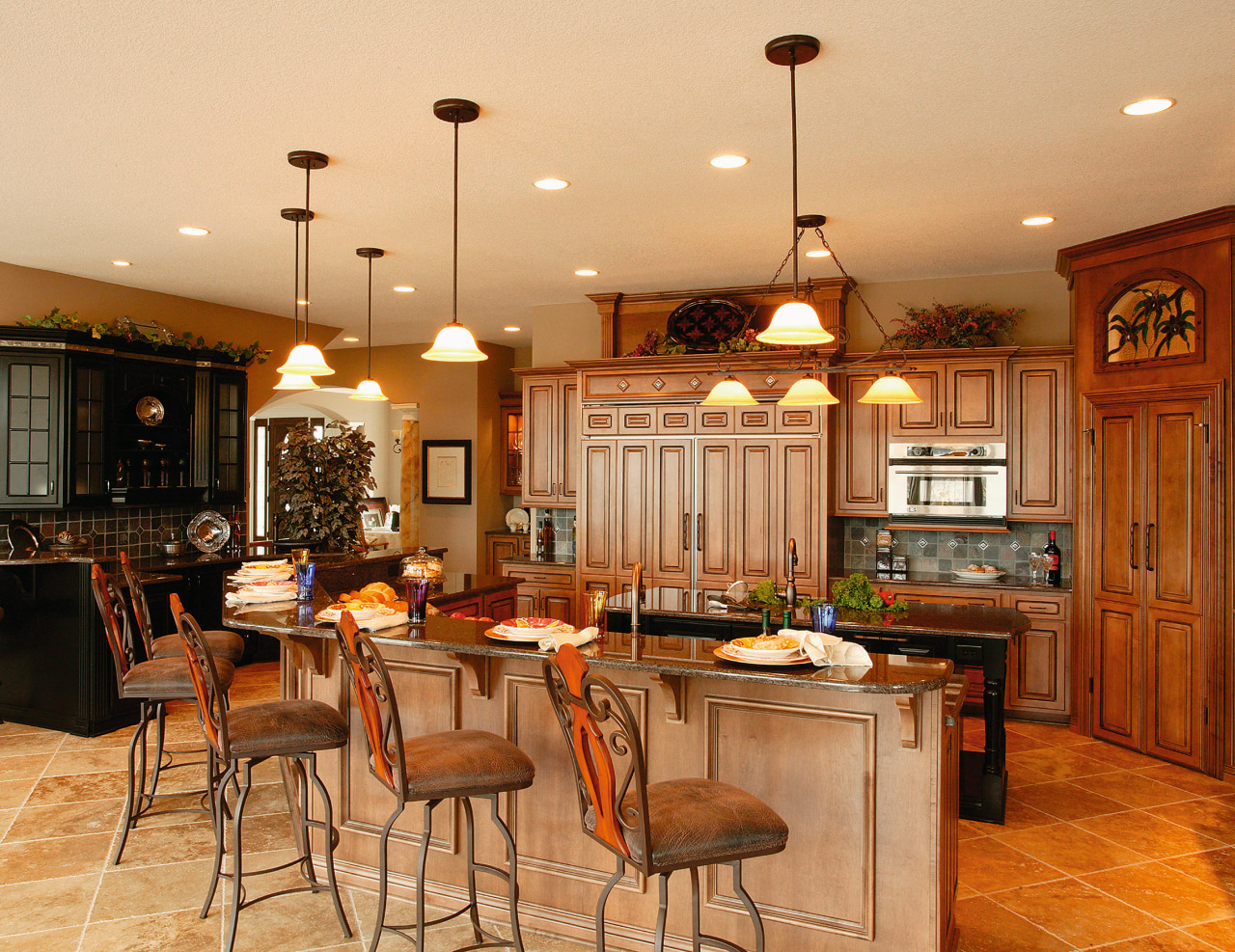 View of this kitchen featuring colonial style tomber cabinetry, ceiling, countertop, cuisine classique, dining room, flooring, interior design, kitchen, room, wood, orange, brown