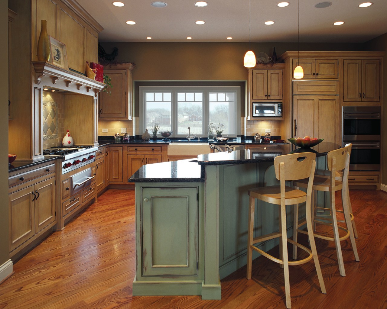 View of this traditional kitchen featuring grean teak cabinetry, countertop, cuisine classique, floor, flooring, hardwood, interior design, kitchen, room, wood flooring, brown