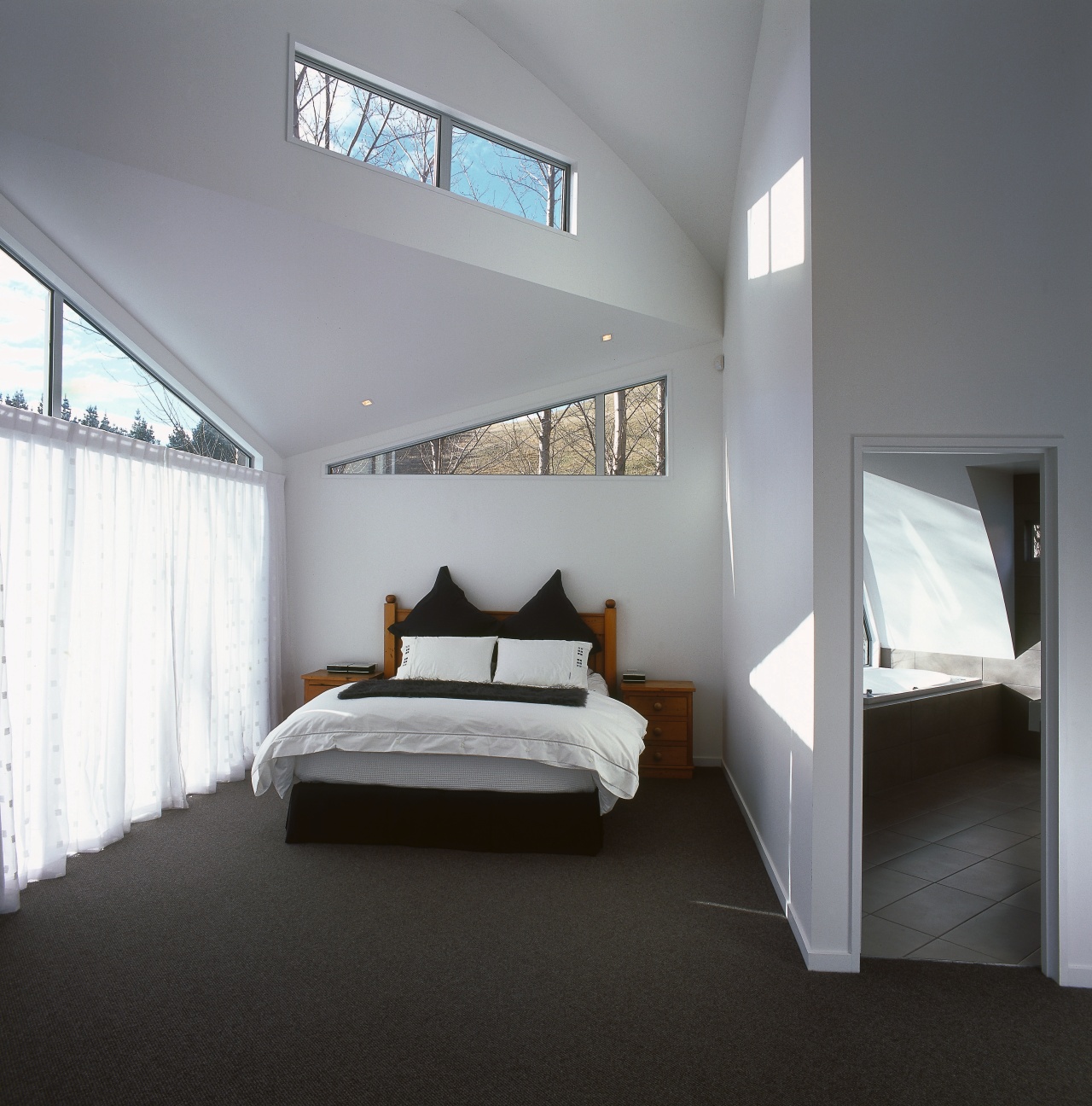 The architect of this rural retreat designed the architecture, bed frame, bedroom, ceiling, daylighting, floor, home, interior design, property, real estate, room, window, gray, black