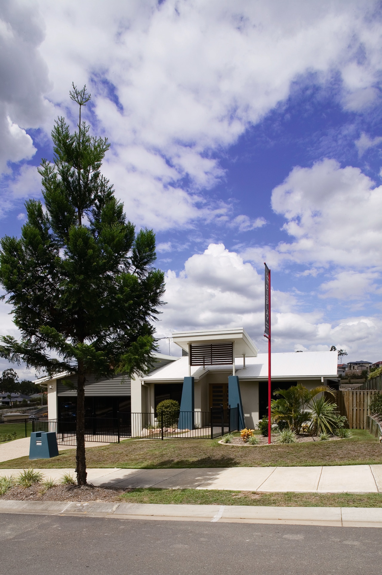 A view of a home developed by Cavalier architecture, building, cloud, facade, home, house, property, real estate, residential area, sky, suburb, tree, gray