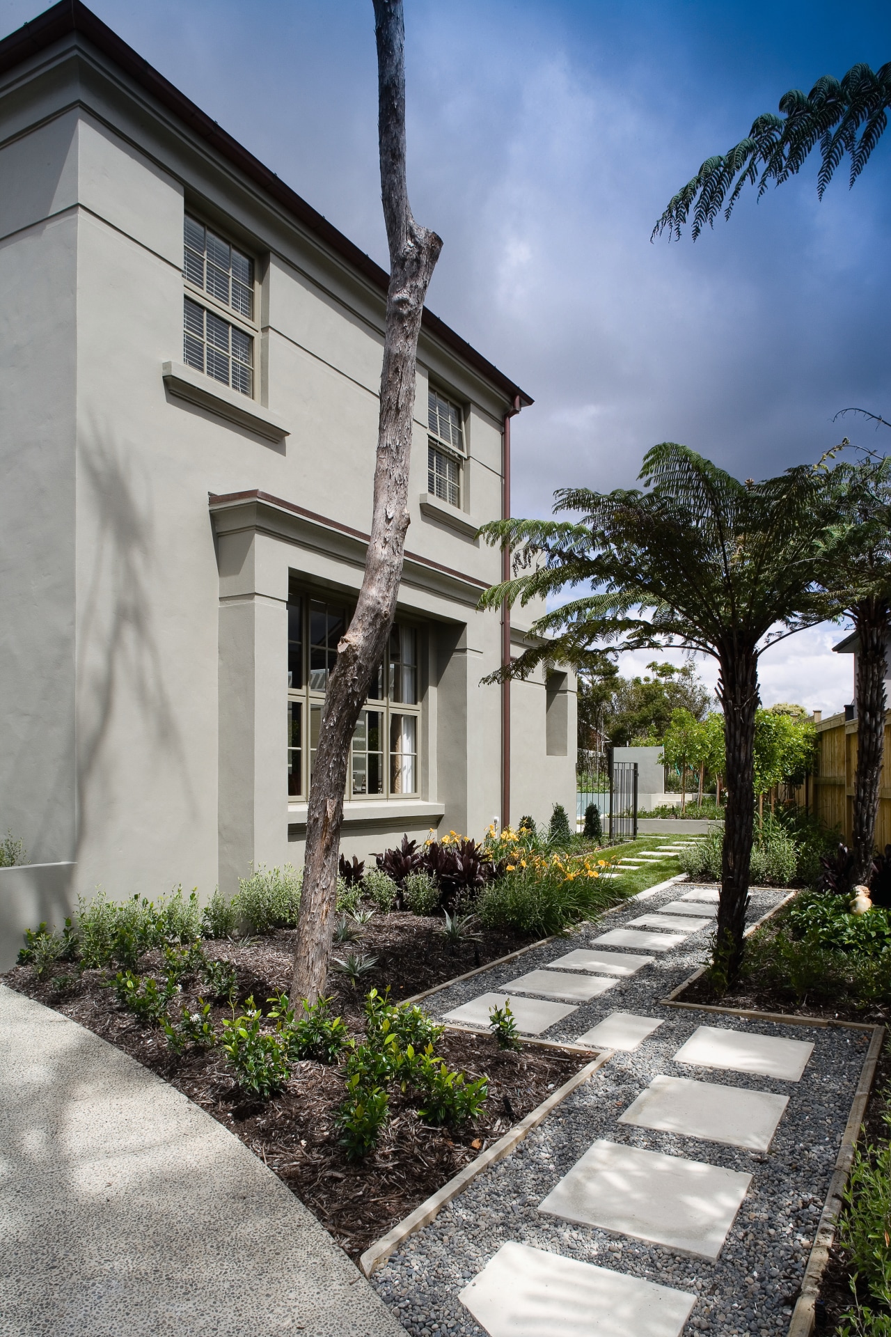 A view of a home designed by Town architecture, building, cottage, estate, facade, home, house, neighbourhood, property, real estate, residential area, sky, tree, villa, walkway, window, gray