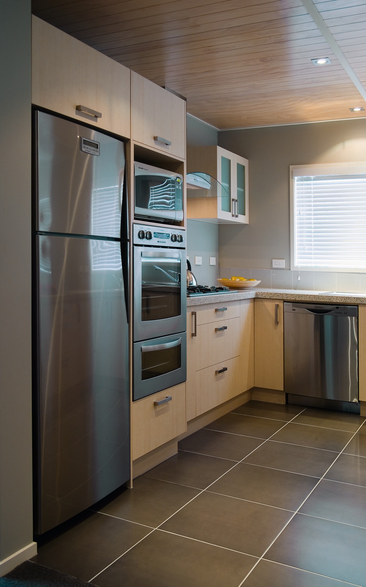 A view of some kitchem appliances from Westinghouse. cabinetry, countertop, floor, flooring, home appliance, interior design, kitchen, kitchen appliance, major appliance, real estate, refrigerator, room, gray, black