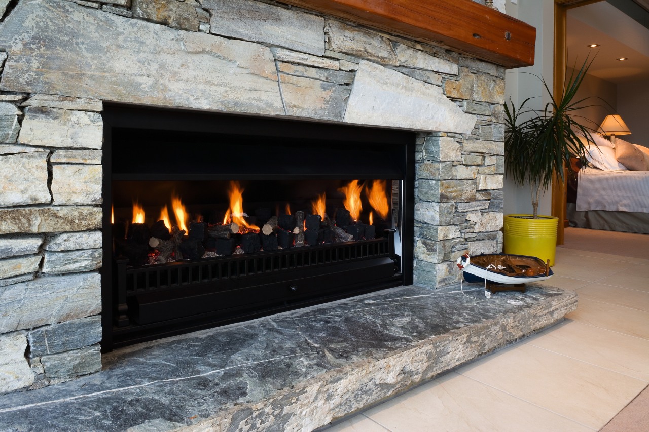 A view of a fireplace from Real Fires fireplace, hearth, heat, wood burning stove, gray, black